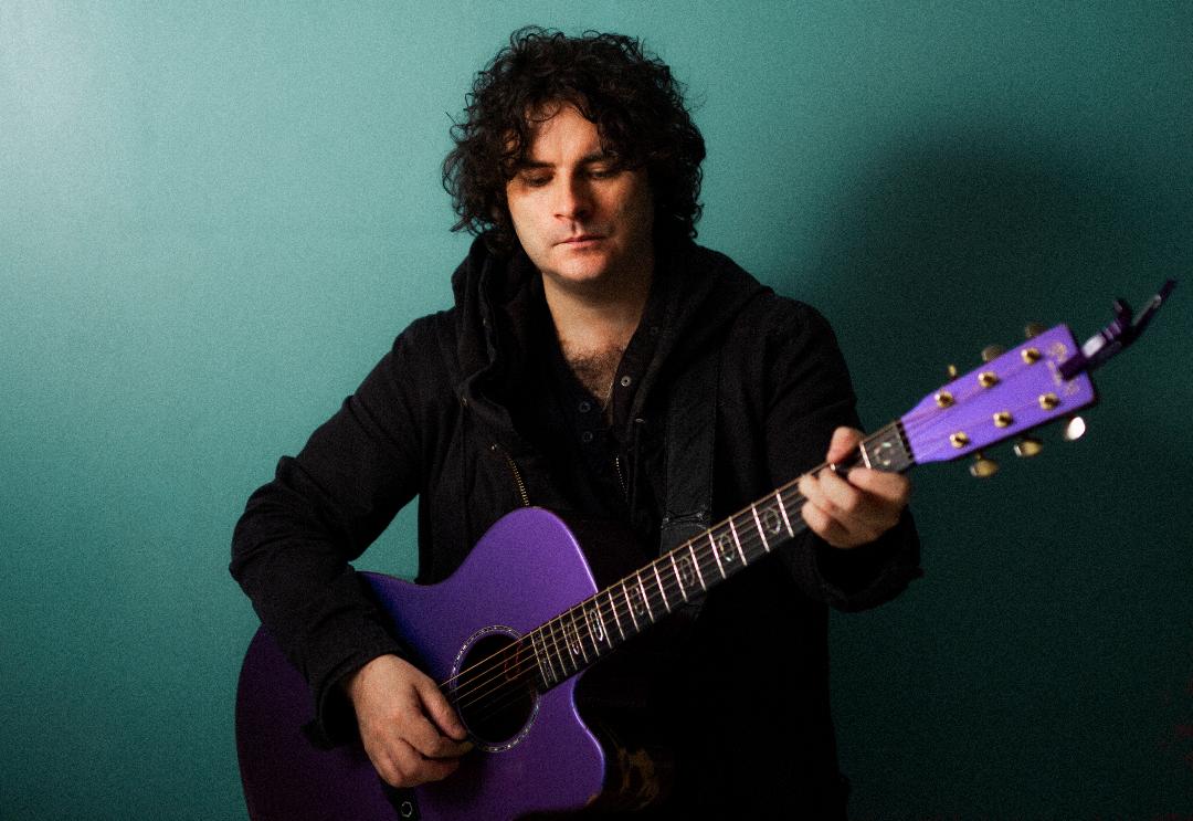 Paddy Casey with Guitar green background 1